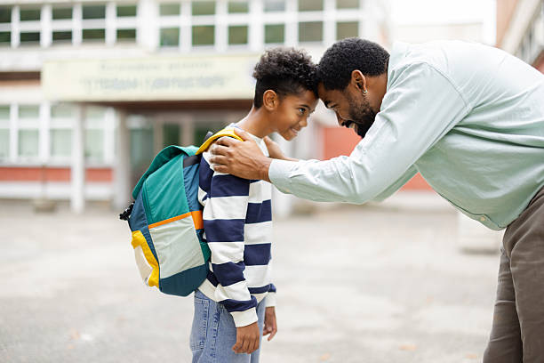 istock Father encouraging son before school in front of the building 2231110880