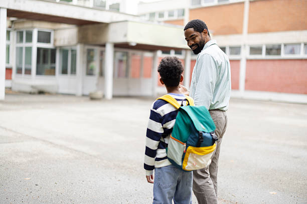 istock Teacher walking with student in schoolyard during recess 2231110904