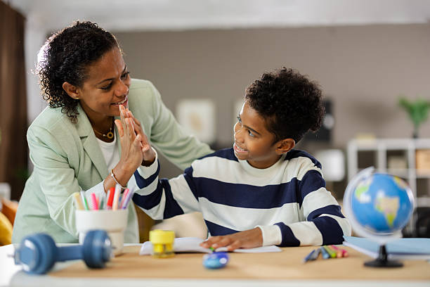 istock Mother and son giving high five after finishing homework 2231110925