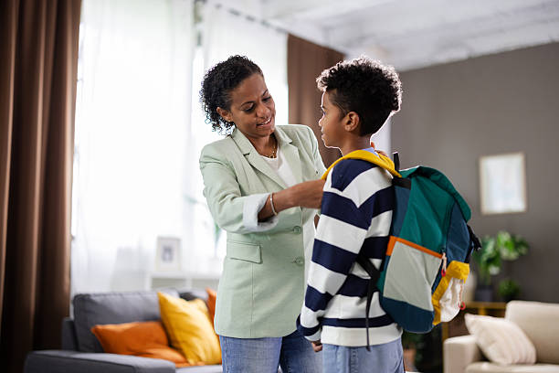 istock Caring mother helping son getting ready for school 2231110932