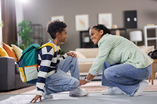 istock Caring mother helping her son getting ready for school 2231110937