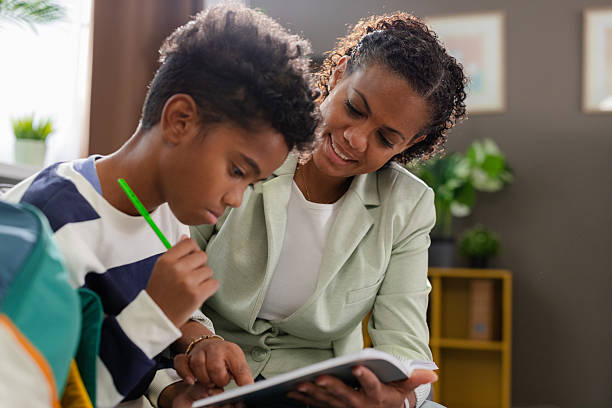 istock Mother helping son with homework, supporting education at home 2231110957