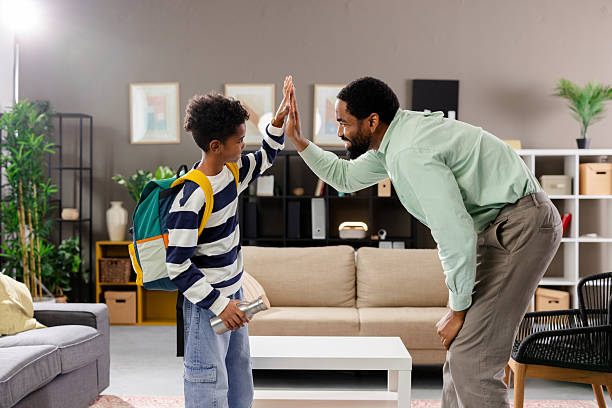 istock Father and son giving high five before school 2231110966