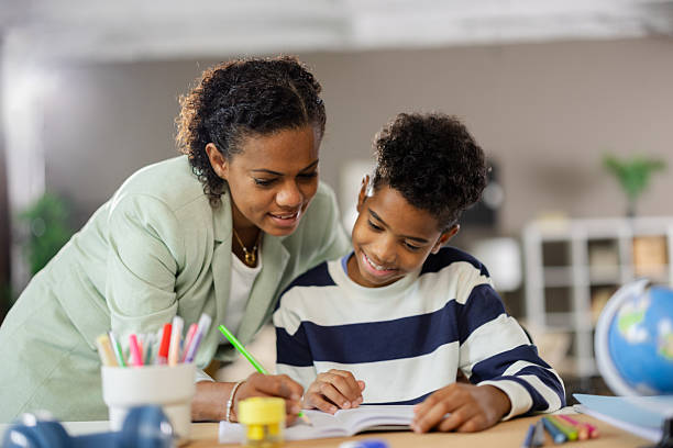 istock Mother helping son with homework at home 2231111107
