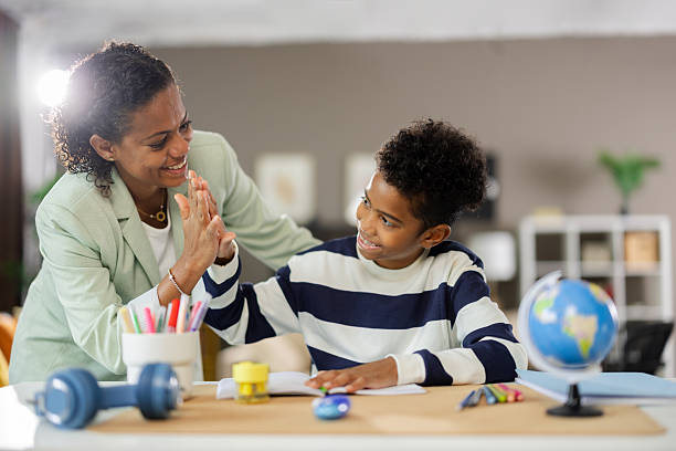 istock Mother and son giving high five after finishing homework 2231111110