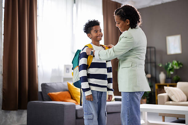 istock Mother helping son getting ready for school in the morning 2231111117