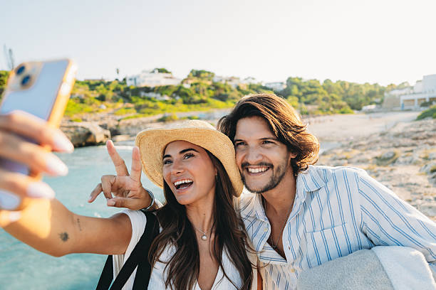 istock Young couple taking a selfie on a beach during summer vacation 2231111846