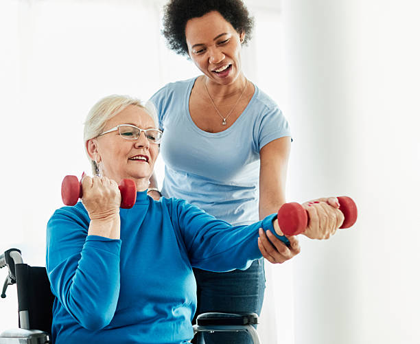 istock senior care exercise physical therapy exercising help assistence retirement home physiotherapy physiotherapist fitness gym strech band clinic therapist elderly woman band stretching 2231112222