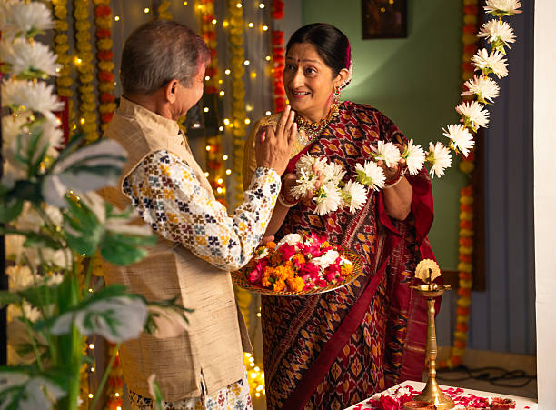 istock Old couple decorating house with garlands during Diwali 2231112699