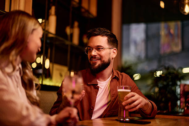 istock Friends Enjoying Drinks Together in a Cozy Bar Setting 2231112765