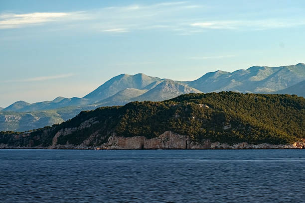 Sunrise over Dubrovnik islands and distant mountains.