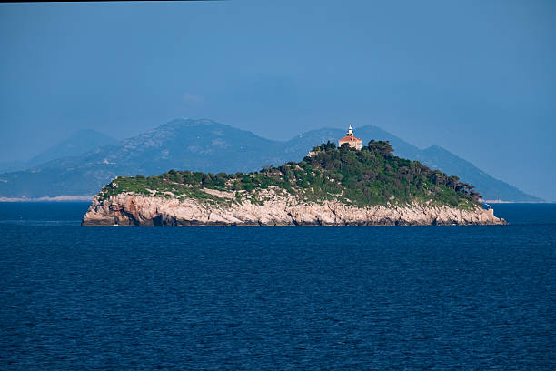 istock Dubrovnik Islands, Lighthouse And Distant Mountains At Sunrise, Dalmatia, Croatia View From The Sea 2231113402