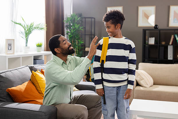 istock Father adjusting backpack of son before school 2231118944