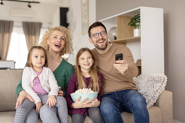 istock Delighted Family Watching Television with Popcorn Together 2231120901