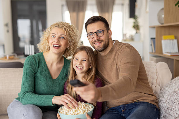 istock Cinematic Joy: Family Enjoyment with Popcorn Together 2231120913