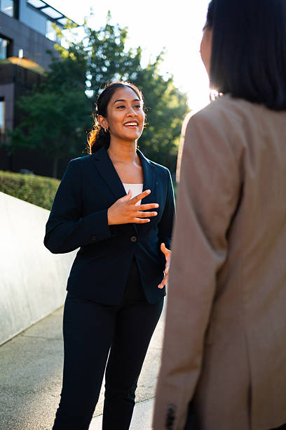 istock Two businesswomen talking outside office building 2231123133