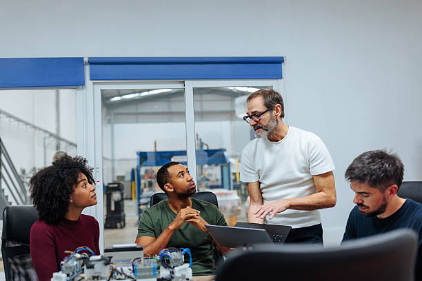 istock Engineers collaborating on innovative project in modern factory office 2231123319