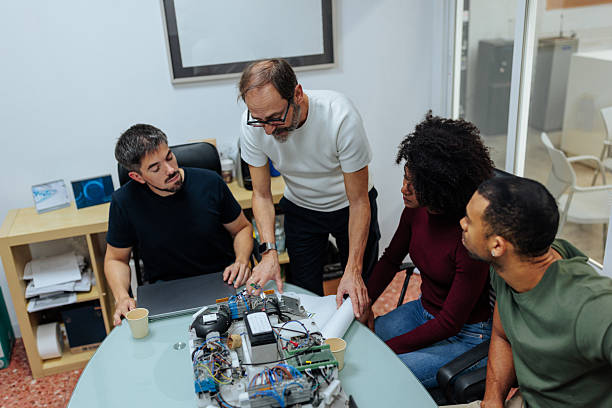 istock Engineers collaborating on building electronic device in office meeting 2231123323