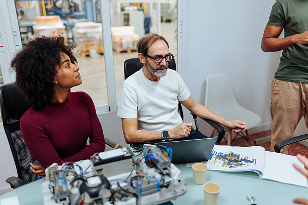 istock Engineers working on robotics project having meeting in office 2231123333