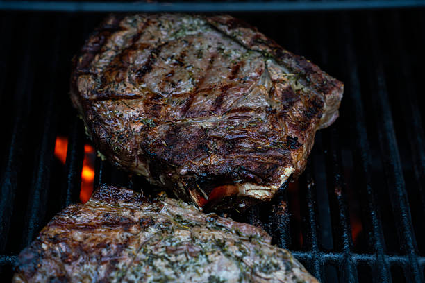 istock Well grilled huge steak on BBQ gas grill 2231123346