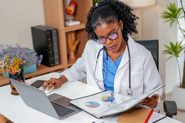 istock Dedicated black female doctor reviews follow up medical record while analyzing data on her laptop. Her focus reflects her commitment to patient care and professionalism 2231130576