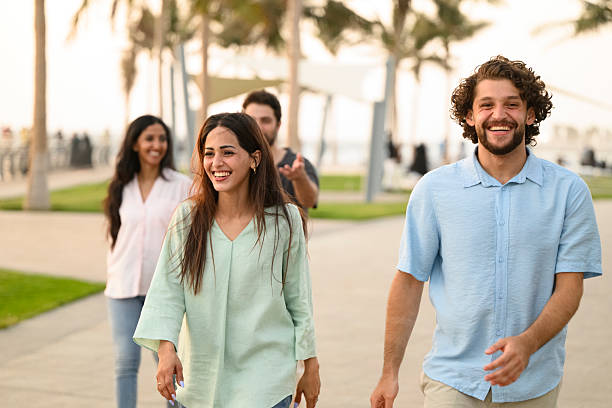 istock Laughing friends enjoying golden hour walk together 2231132982
