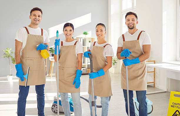 istock Happy janitors in uniform from professional cleaning service looking at camera. 2231134533