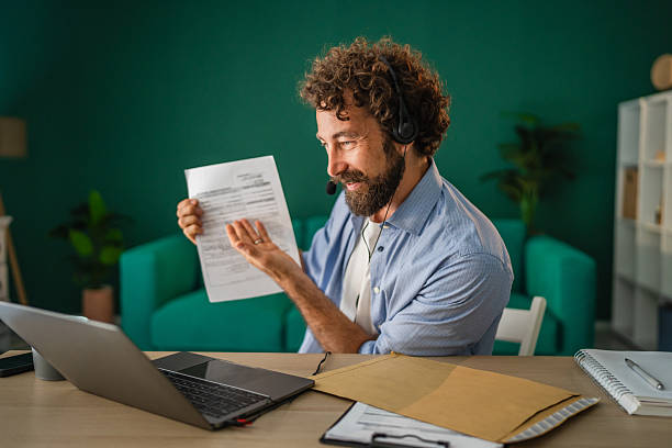 istock Businessman showing document during video call working remotely from home office 2231135462
