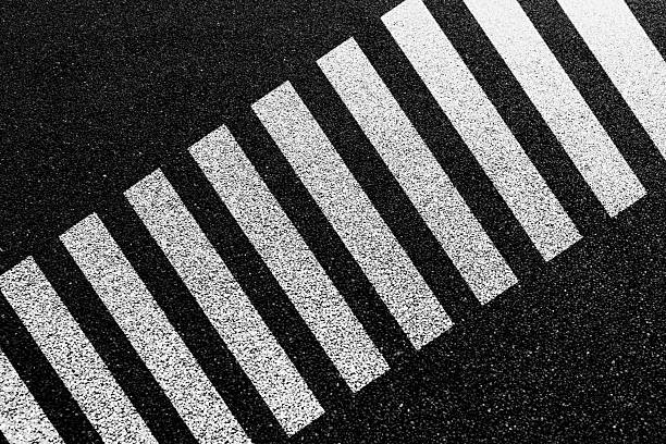 Zebra crossing sign on asphalt road
