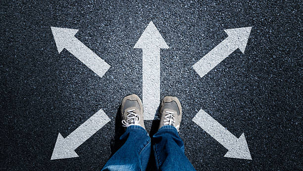 istock Taking decisions for the future, man standing with multitude of arrows in different direction 2231135977