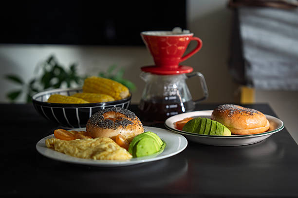 Breakfast Plate with Bagel, Avocado, Omelette, and Tomatoes