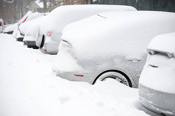 istock vehicles covered with snow after blizzard in parking area 2231139676