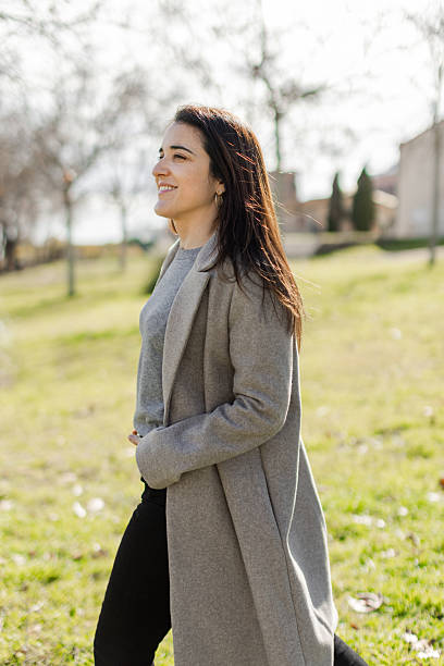 istock Peaceful woman walking outdoors with soft smile 2231140819