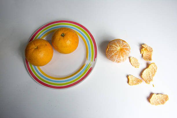 istock peeled tangerine and orange on a  table 2231141997