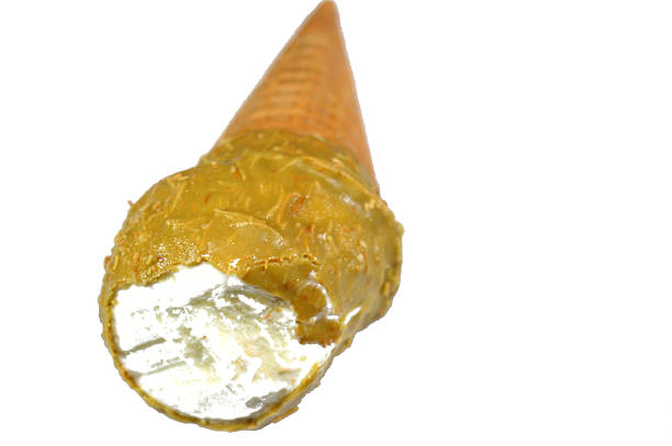 Ice cream vanilla cone with caramel coated with pistachio layer and Kunafa Konafa and nuts in a crispy wafer cones, melting cold ice cream twirl in a wafer biscuits, summer holiday concept