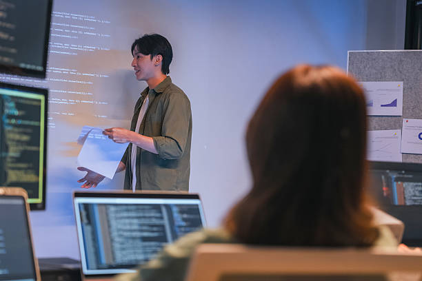 istock Our vibrant programmer team brainstorm discuss at night to discuss project goals and various strategic innovations. We actively reviewed code, focusing on the development of vital systems vision 2231144178