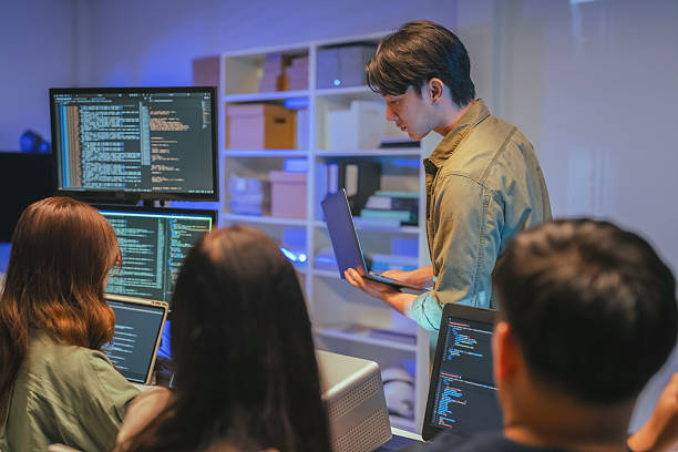 istock Young Asian man software developers mentor leader manager Verification and validation in software testing ensure developers drive the development of engineering technologies Programmer development 2231144535
