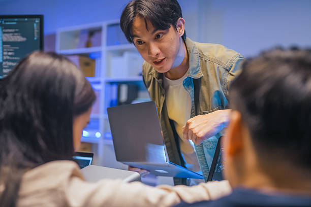 istock Young Asian man software developers mentor leader manager Verification and validation in software testing ensure developers drive the development of engineering technologies Programmer development 2231144600