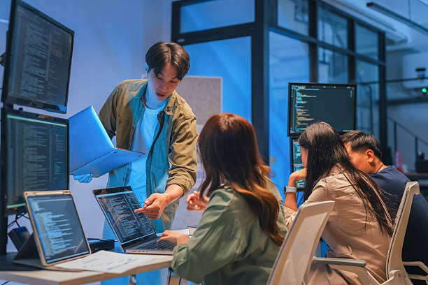 istock Young Asian man software developers mentor leader manager Verification and validation in software testing ensure developers drive the development of engineering technologies Programmer development 2231144617