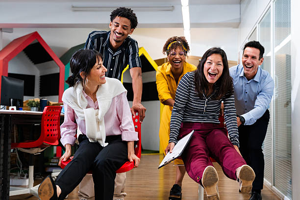 istock Happy business team having fun on office chairs in startup office 2231144842