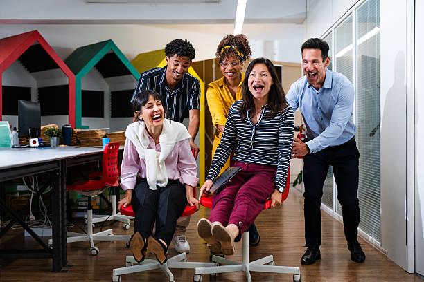 istock Business people having fun on office chairs in startup office 2231144952