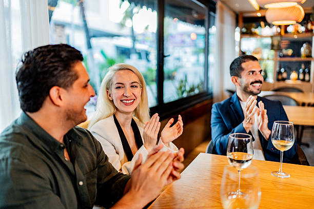 istock Coworkers applauding at restaurant 2231146275