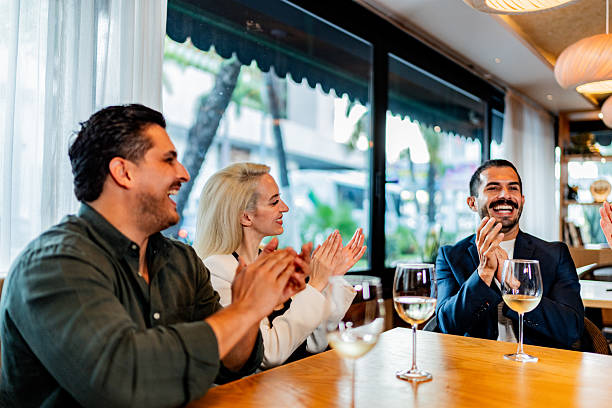 istock Coworkers applauding at restaurant 2231146287