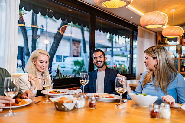istock Coworkers talking during lunch at restaurant 2231146352