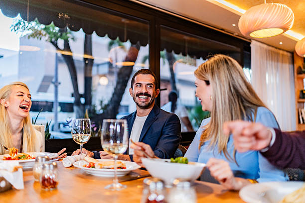 istock Coworkers talking during lunch at restaurant 2231146360
