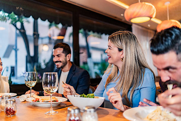 istock Coworkers talking during lunch at restaurant 2231146381
