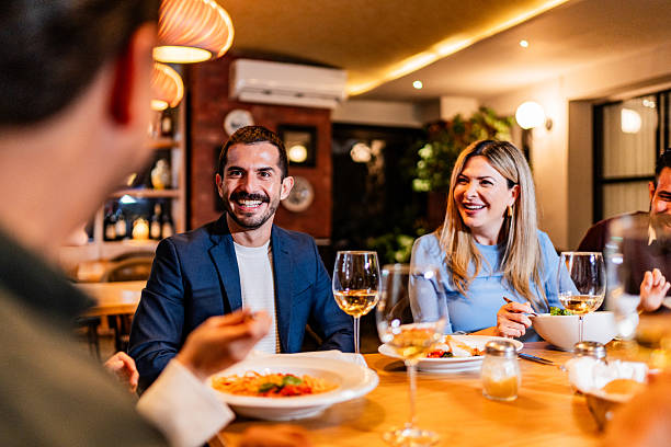 istock Coworkers talking during lunch at restaurant 2231146386