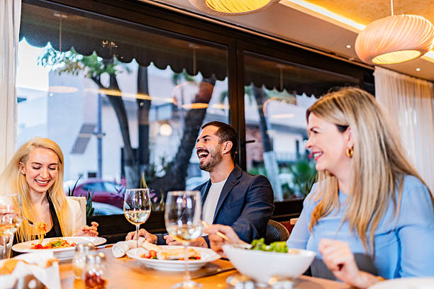istock Coworkers talking during lunch at restaurant 2231146408