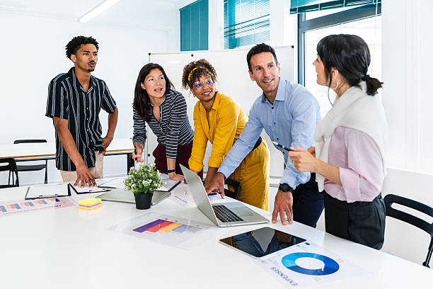 istock Business people collaborating on project in startup office meeting 2231146545