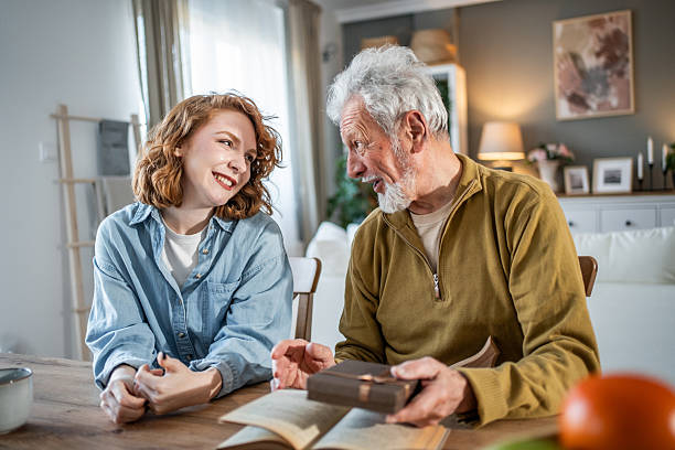 istock Senior man sharing wisdom with young woman while reading bible 2231147551